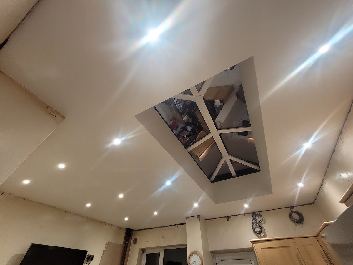 A roof lantern fitted into a kitchen ceiling, with spotlights around it